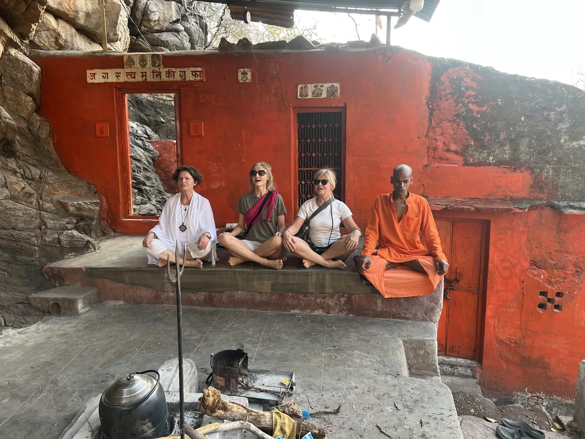 Visitors and a sadhu gather near the cave shrine