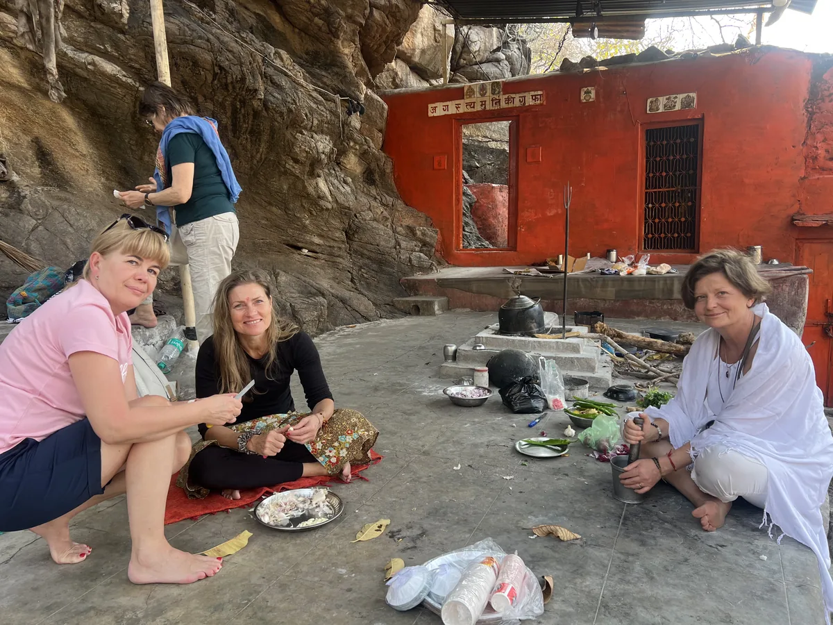 A group shares a meal after cooking at the cave