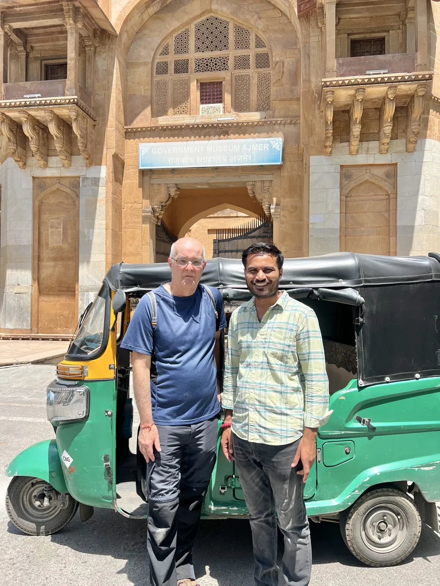 Manish and a visitor outside an Ajmer heritage site