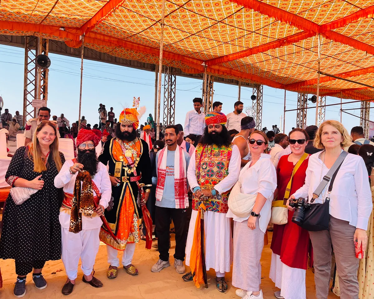 Visitors gather beneath a canopy at the Pushkar Camel Fair