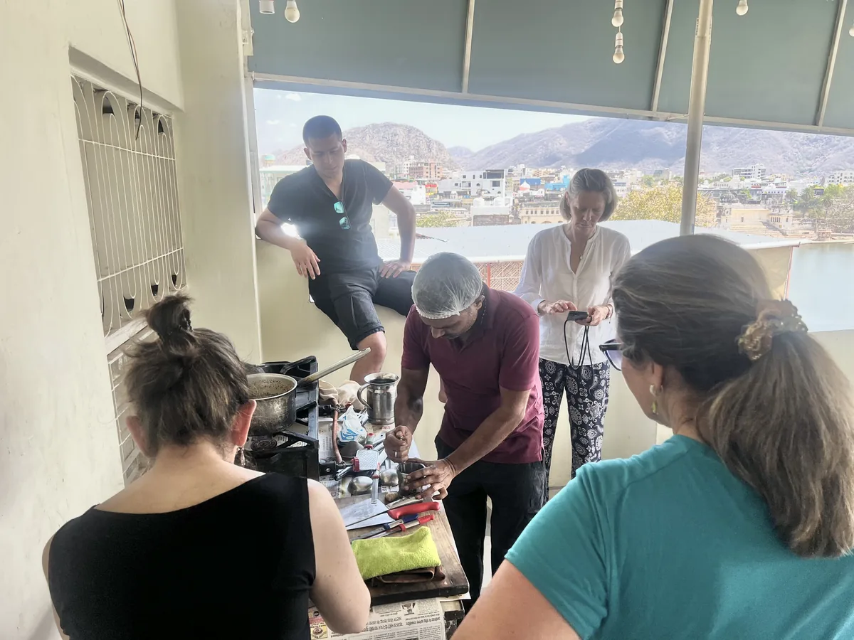 Guests prepare a meal during a Pushkar cooking class
