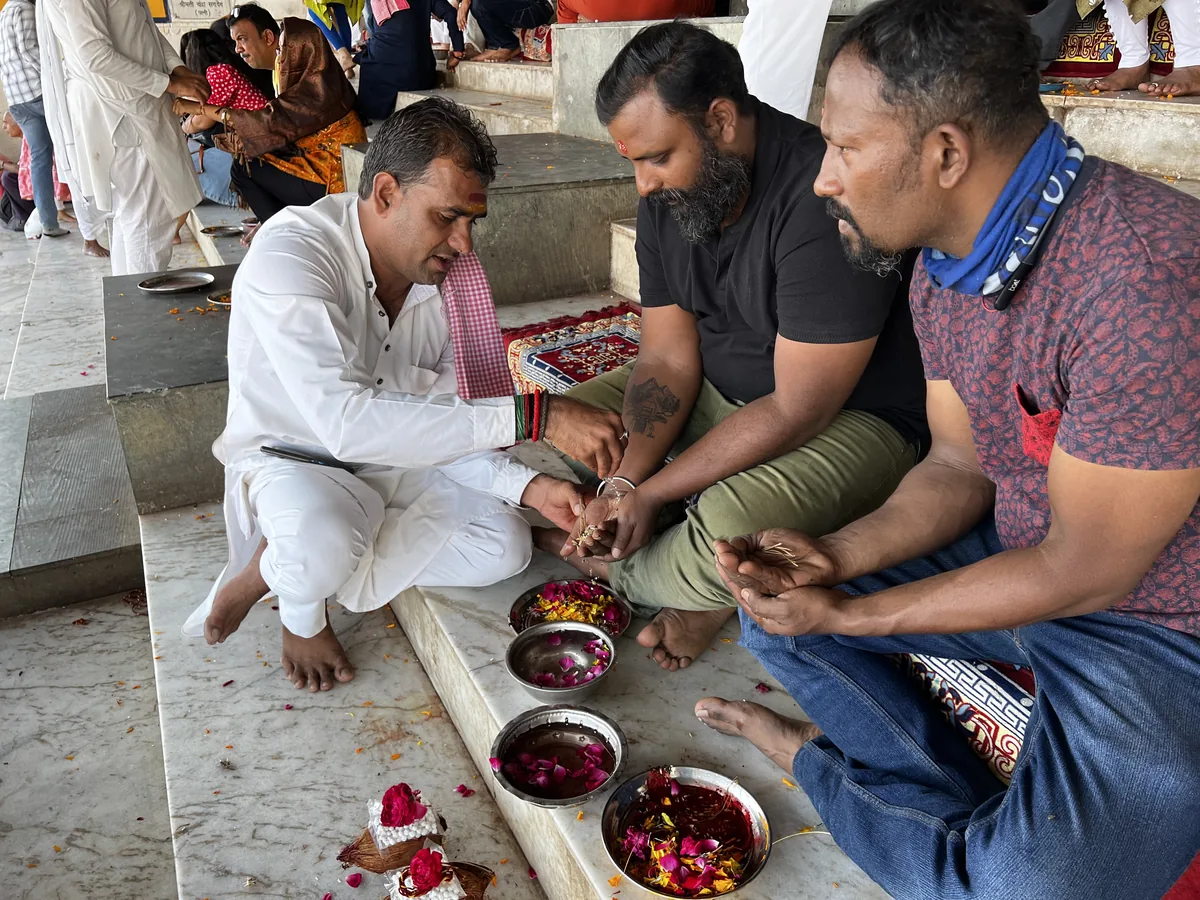 A family performs a water offering during Tarpan in Pushkar