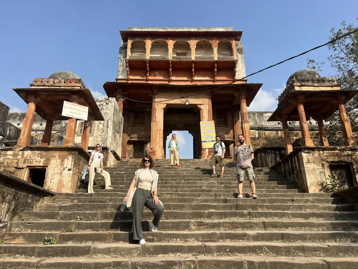 Visitors walk up the steps of a temple in Pushkar