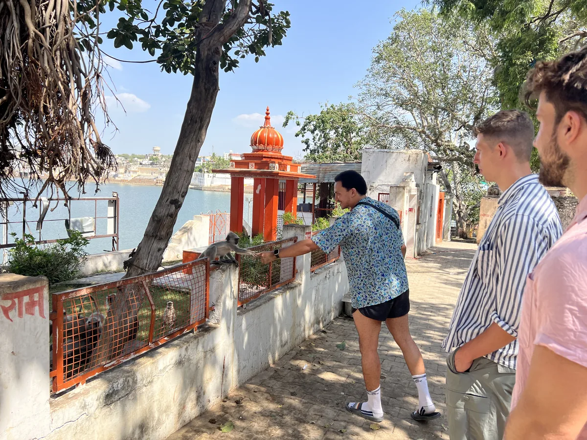A visitor explores a temple beside Pushkar Lake