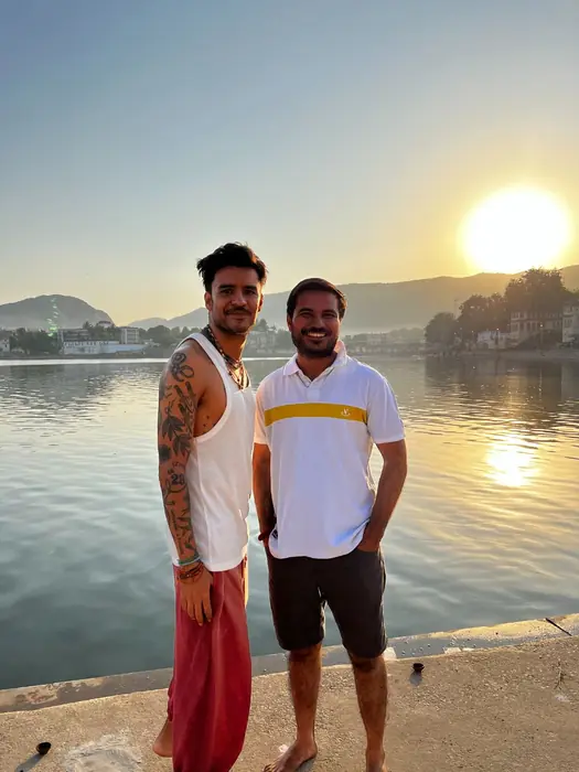 Two visitors beside Pushkar Lake in the morning light