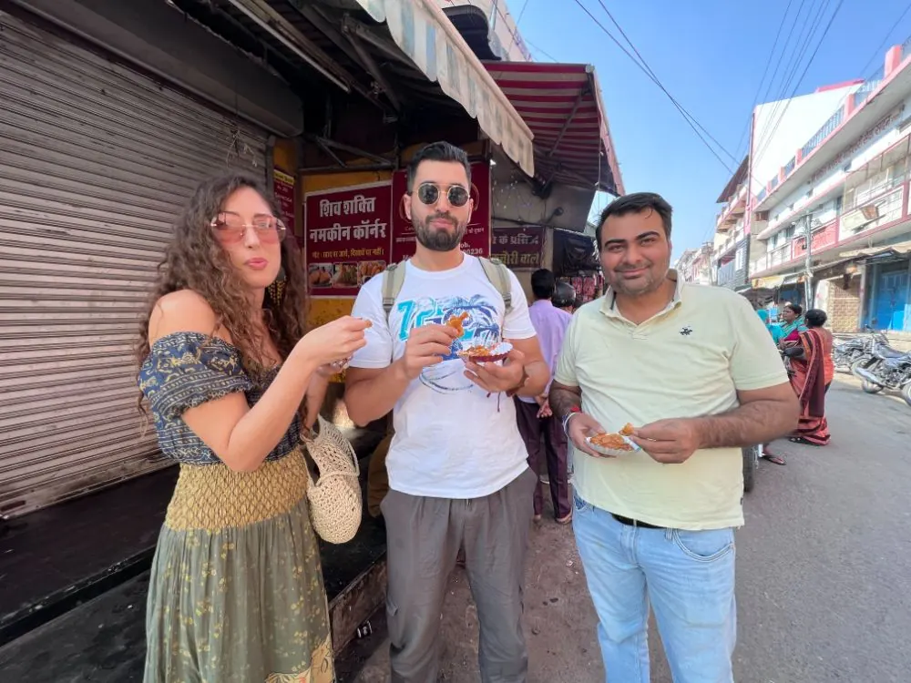 A guide and travellers explore a Pushkar market lane